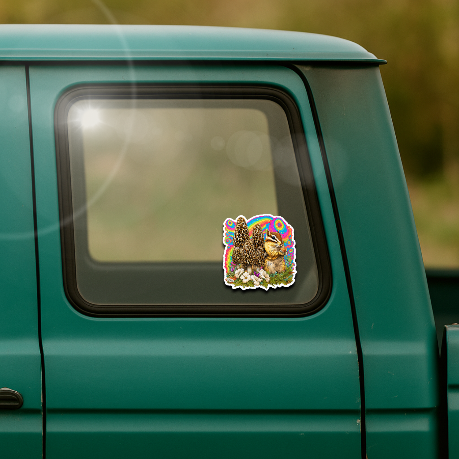 Sticker of a cartoon character on the window of a teal vehicle with a blurred natural background